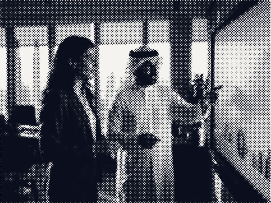 Two colleagues reviewing charts in a Dubai office