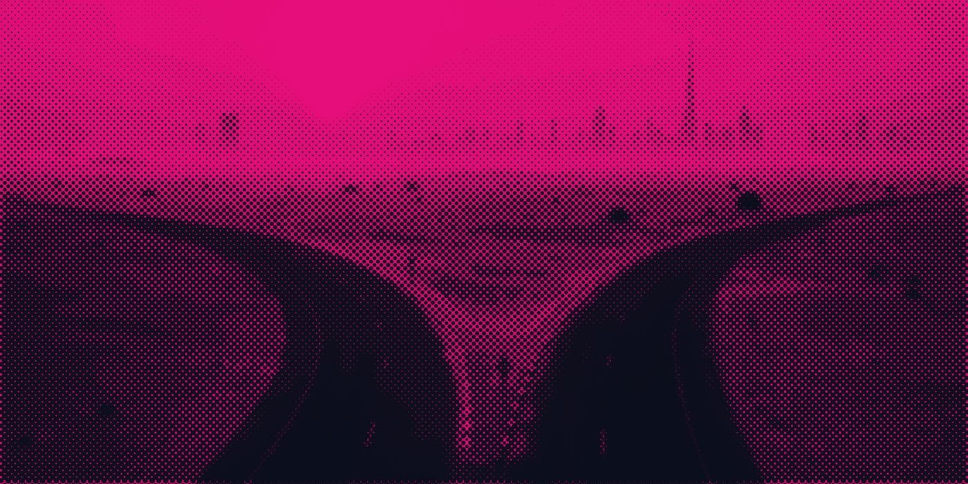 A desert road splitting in two at sunrise